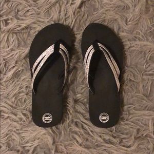 Black flip flops with silver glitter straps